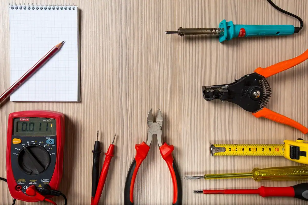 Ruletă și caiet pe un banc de lucru, pentru măsurarea corectă a costului unui obiectiv